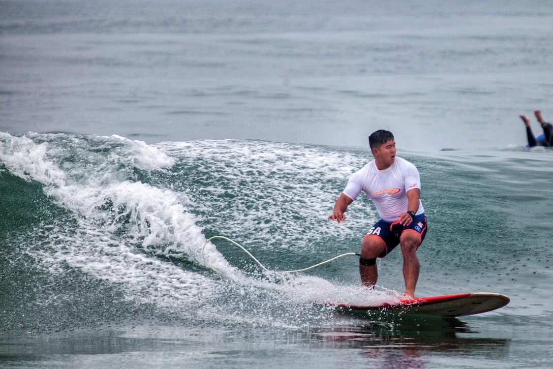 U.S. Marine Corps 1st Lt. Dane Oshiro, assistant operations officer, 9th Communication Battalion, I Marine Expeditionary Force, rides a wave during the annual Commanding General’s (CG's) Cup Surfing Competition, at the Del Mar Beach Resort on Marine Corps Base Camp Pendleton, California.