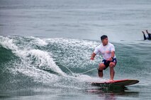 U.S. Marine Corps 1st Lt. Dane Oshiro, assistant operations officer, 9th Communication Battalion, I Marine Expeditionary Force, rides a wave during the annual Commanding General’s (CG's) Cup Surfing Competition, at the Del Mar Beach Resort on Marine Corps Base Camp Pendleton, California.