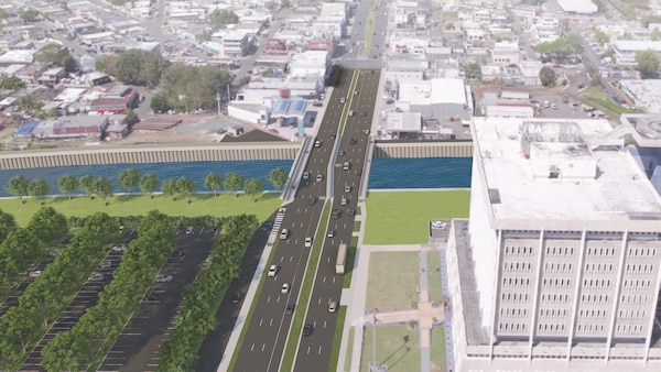 Rendering of a bridge over a river with a large parking lot next to the bridge.