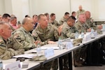 Maj. Gen. Thomas Friloux, adjutant general of Louisiana, discusses briefing details with Col. Augusto Villalaz, director of the Joint Staff for the Louisiana National Guard, during the annual Hurricane Rehearsal of Concept (ROC) Drill at the Armed Forces Reserve Center in Baton Rouge, Louisiana, May 21, 2025. The drill helps synchronize plans and strengthen coordination across LANG’s senior leadership ahead of hurricane season.