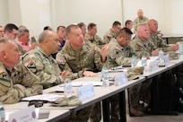 Maj. Gen. Thomas Friloux, adjutant general of Louisiana, discusses briefing details with Col. Augusto Villalaz, director of the Joint Staff for the Louisiana National Guard, during the annual Hurricane Rehearsal of Concept (ROC) Drill at the Armed Forces Reserve Center in Baton Rouge, Louisiana, May 21, 2025.