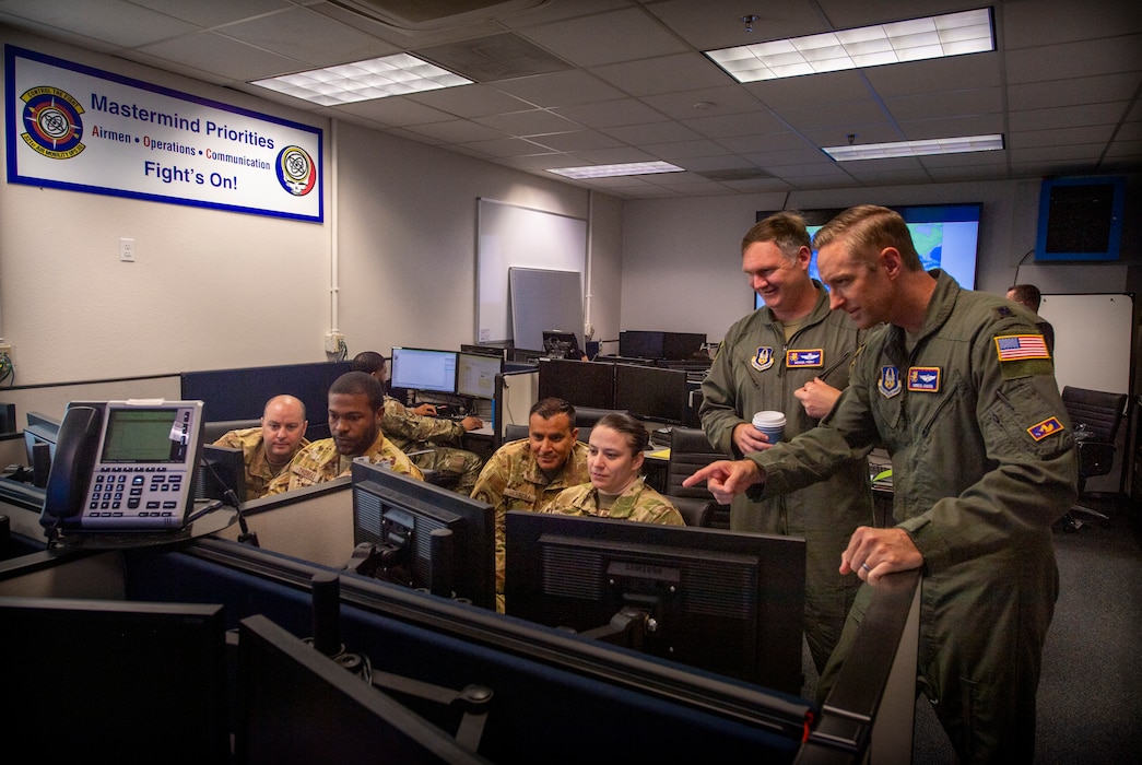 People gather around a desktop computer