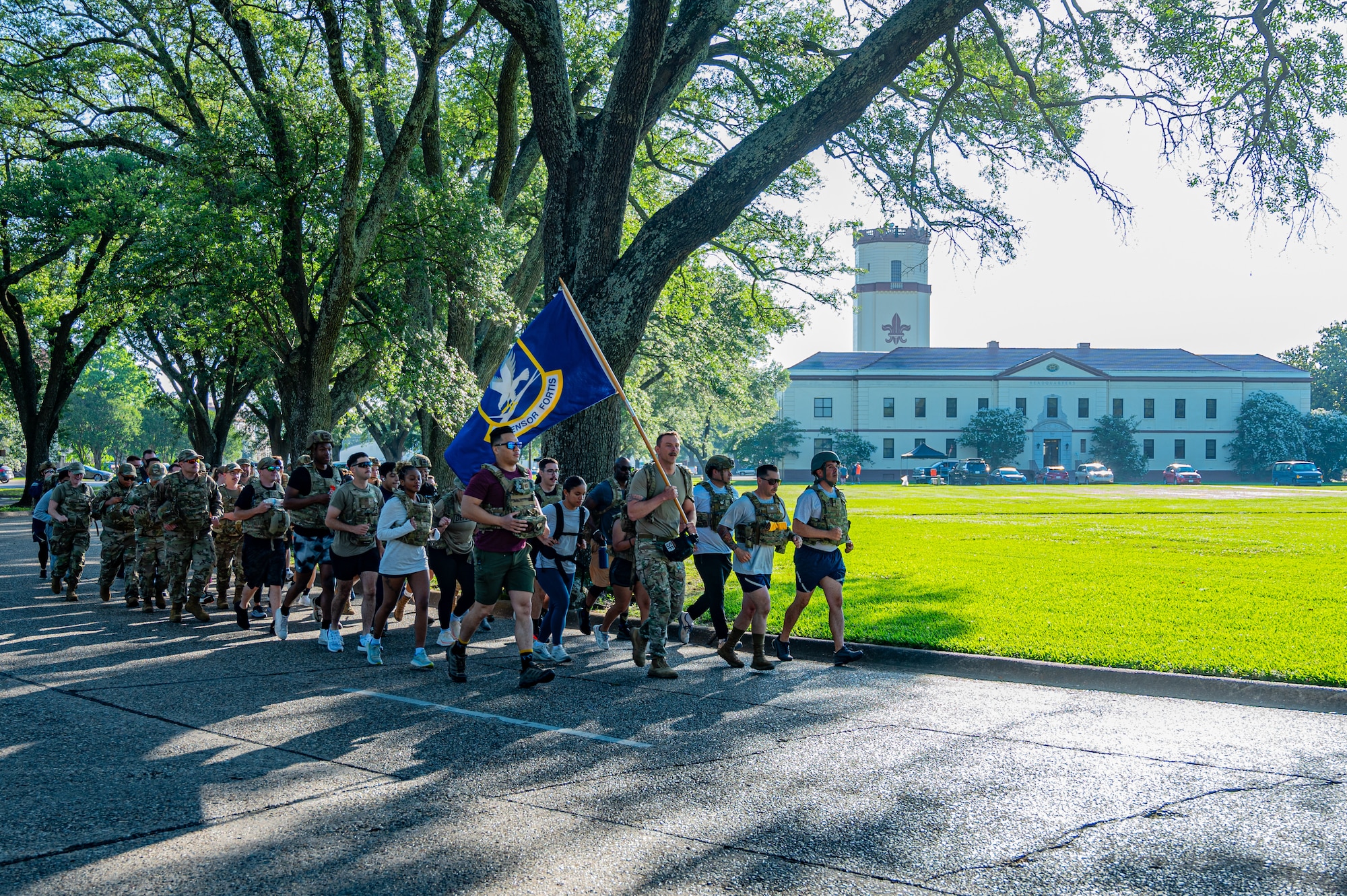 A group of Airmen at Barksdale Air Force Base, Louisiana, jog with the security forces flag during a 24-hour Police Week ruck, May 22, 2025. The 24-hour ruck was one of the many events held to commemorate Police Week. (U.S. Air Force photo by Airman 1st Class Aaron Hill)