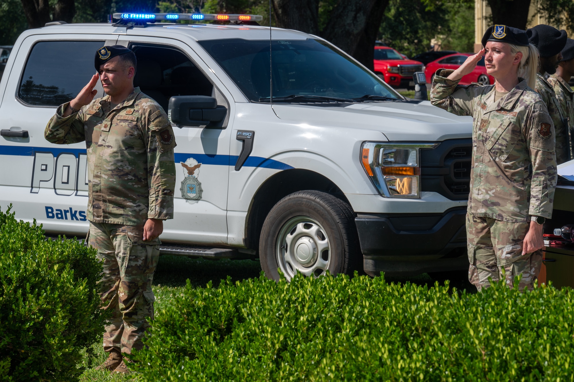 U.S. Air Force Maj. Raymond Taboada, 2nd Security Forces Squadron commander, left, and Tech. Sgt. Kaila Craven, 2nd Security Forces Squadron security manager, right, render salutes during a closing ceremony for Police Week at Barksdale Air Force Base, Louisiana, May 22, 2025. The 2nd Bomb Wing held an observance honoring past and present law enforcement personnel, showing gratitude for the defenders’ unwavering commitment to protecting Airmen and assets vital to the long-range strike mission. (U.S. Air Force photo by Airman 1st Class Preston Crawford)