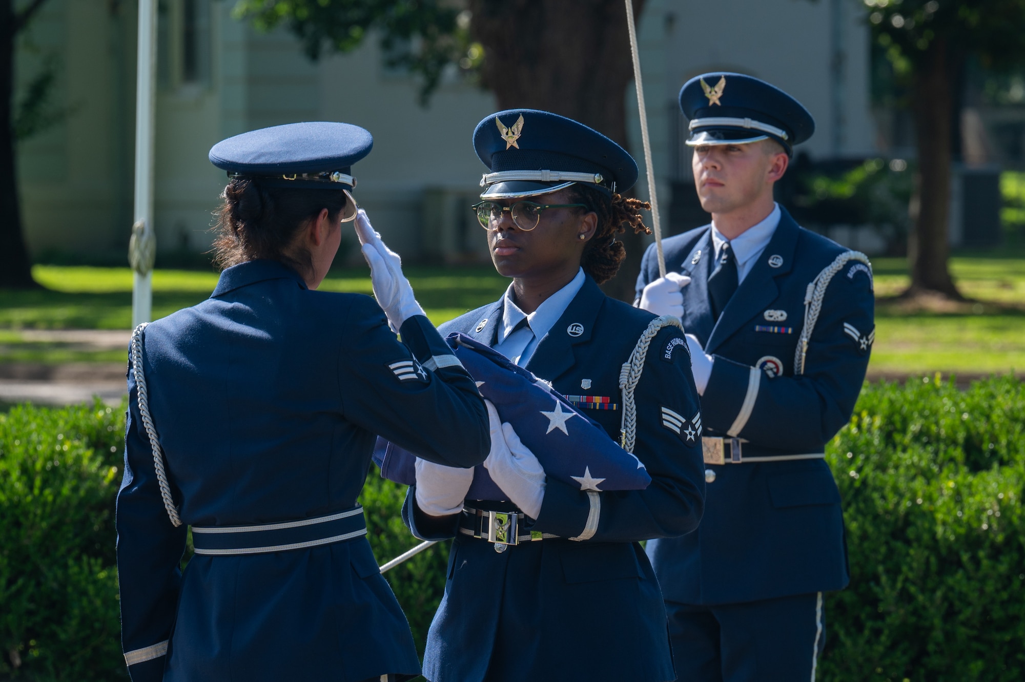 U.S. Air Force Senior Airman Tatiana Alvarez, left, 2nd Force Support Squadron Honor Guard member, renders a salute to Senior Airman Martayshia Brown, center, and Airman 1st Class Coen Rader, right, 2nd Force Support Squadron Honor Guard members, during a closing ceremony for the observance of Police Week at Barksdale Air Force Base, Louisiana, May 22, 2025. The Barksdale Honor Guard performed the folding of the U.S. flag during the ceremony, honoring past defenders who have given their lives in the line of duty. (U.S. Air Force photo by Airman 1st Class Preston Crawford)