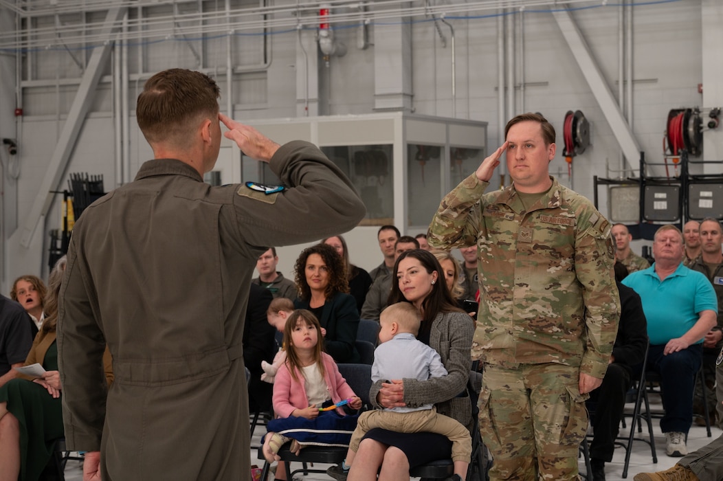 U.S. Air Force Lt. Col. Jay Doerfler, left, 354th Range Squadron outgoing commander, renders a final salute to Staff Sgt. Kjell Olson, 354th Range Squadron plans and programs, during a change of command ceremony