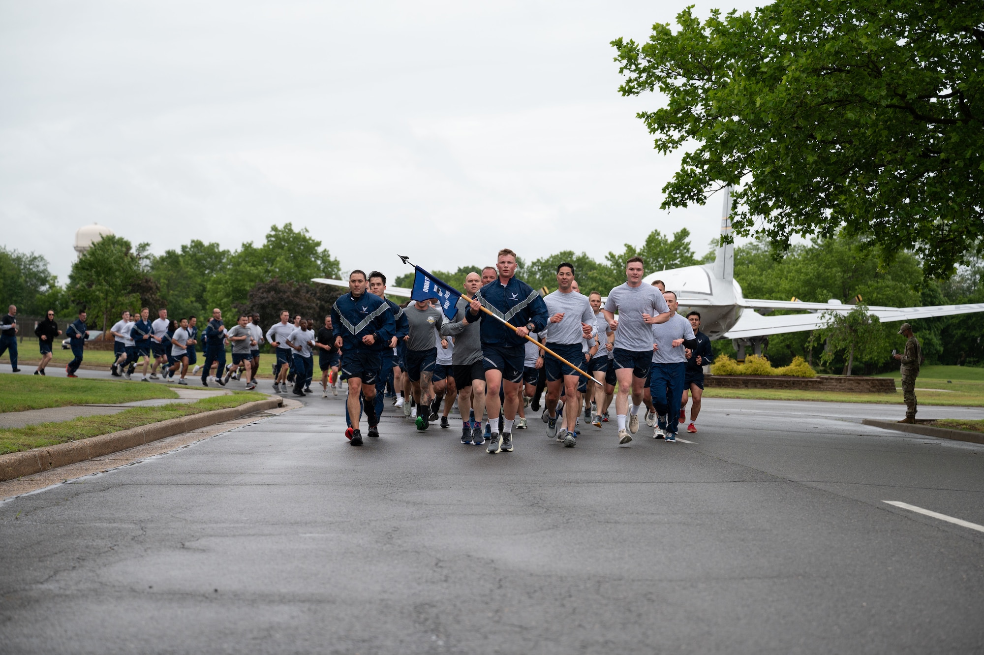 U.S. Air Force Airmen assigned to aerial port squadrons run to the finish during the 12th annual Port Dawg Memorial Run at Joint Base McGuire-Dix-Lakehurst, N.J., May 21, 2025. Members of the Port Dawg community from the 305th Air Mobility Wing, 621st Contingency Response Wing and the USAF Expeditionary Center came together for this year's annual run, which honors fallen active duty, Air National Guard and Reserve Air Transportation teammates, known as Port Dawgs, who lost their lives throughout the year. (U.S. Air Force photo by Airman Haeleigh Bayle)