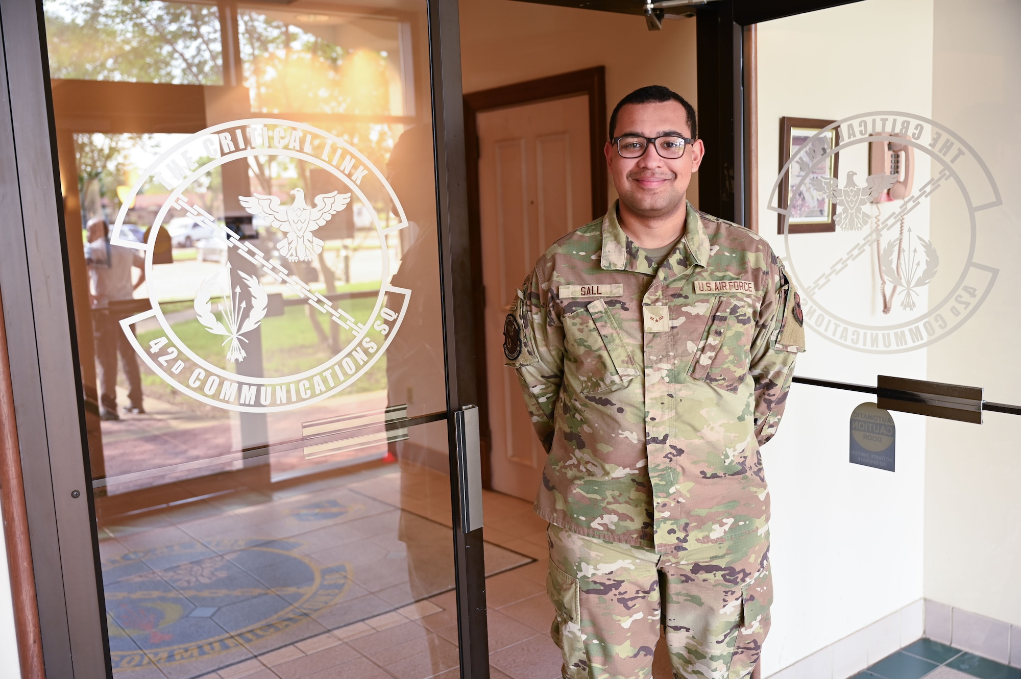 U.S. Air Force Airman 1st Class Mohamed Sall, 42nd Communications Squadron communications focal point technician, poses in front of the 42nd CS entrance at Maxwell Air Force Base, Alabama May 20, 2025.