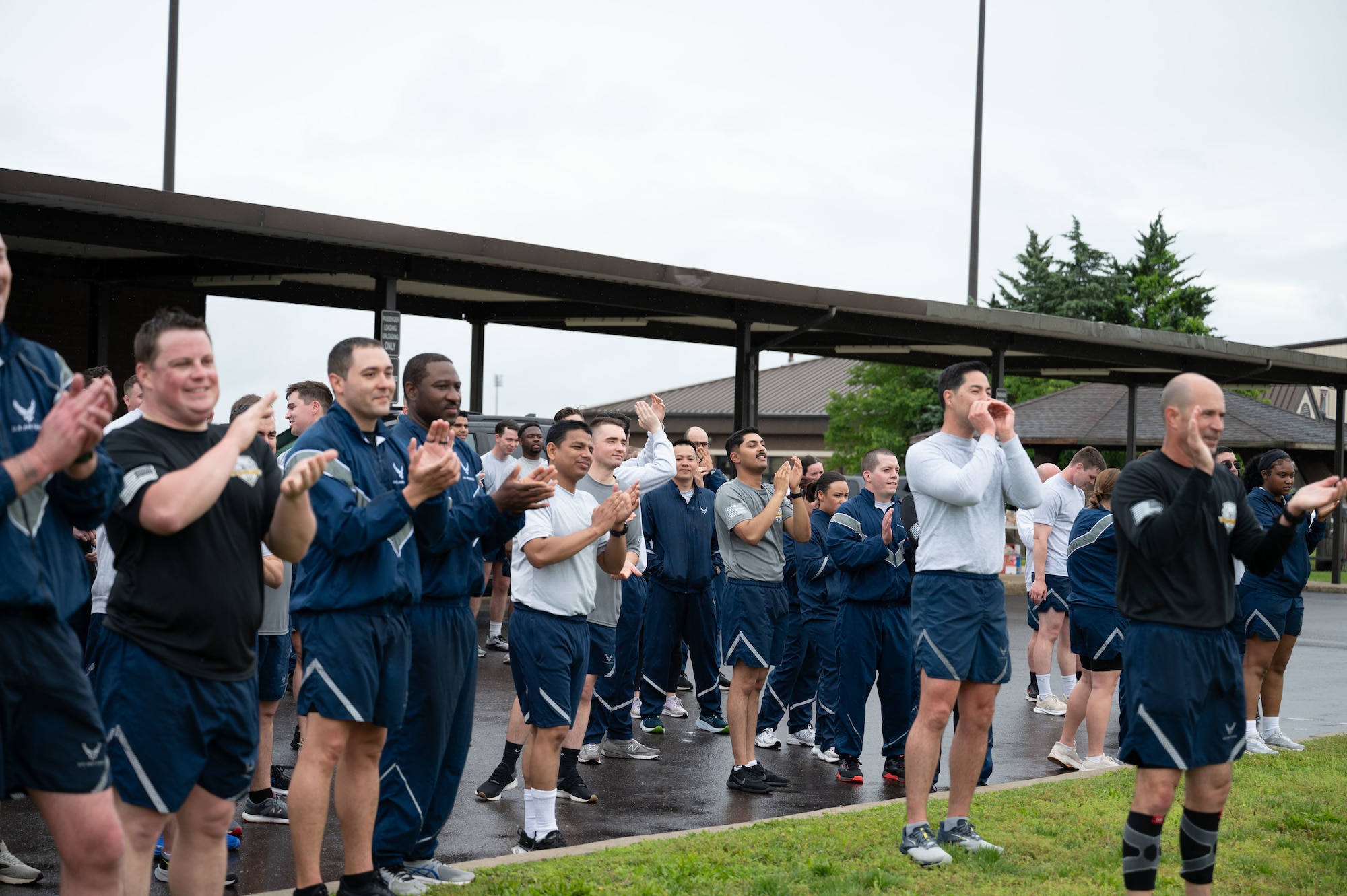 U.S. Air Force Aerial Port Squadrons  from multiple wings at Joint Base McGuire-Dix-Lakehurst, N.J., cheer on the final runners as they finish the annual Port Dawg Memorial Run May 21, 2025. The memorial run is hosted each year to honor fallen Active Duty, Guard, and Reserve Air Transportation teammates, known as Port Dawgs, who lost their lives throughout the year. (U.S. Air Force photo by Airman Haeleigh Bayle)