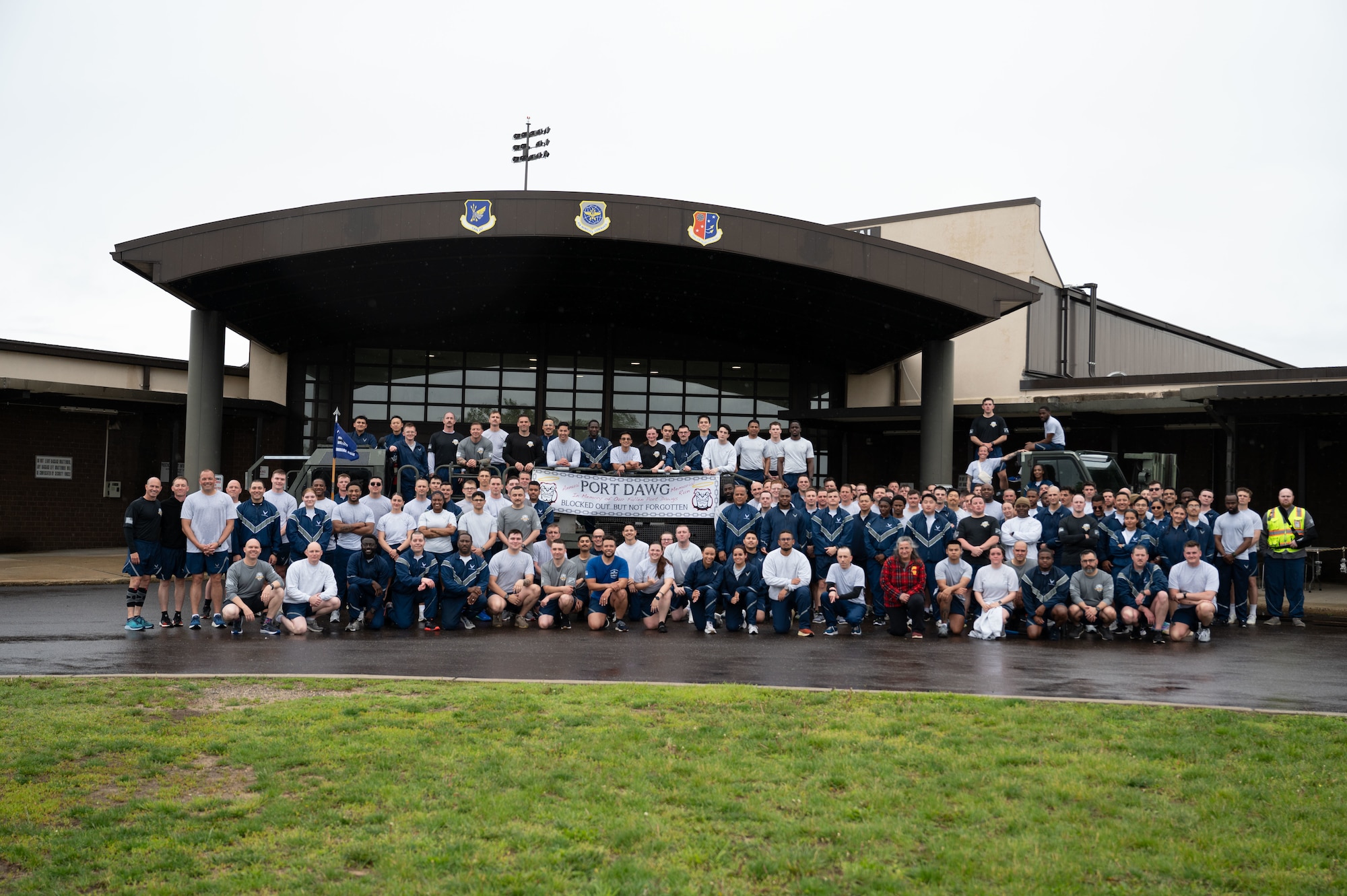 U.S. Air Force Aerial Port Squadrons gather for a picture after their annual Port Dawg Memorial Run at Joint Base McGuire-Dix-Lakehurst, N.J., May 21, 2025. This year marked the 12th anniversary of the memorial run to honor those that lost their lives in the Port Dawg community. (U.S. Air Force photo by Airman Haeleigh Bayle)