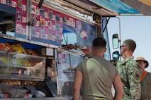 People stand at food truck