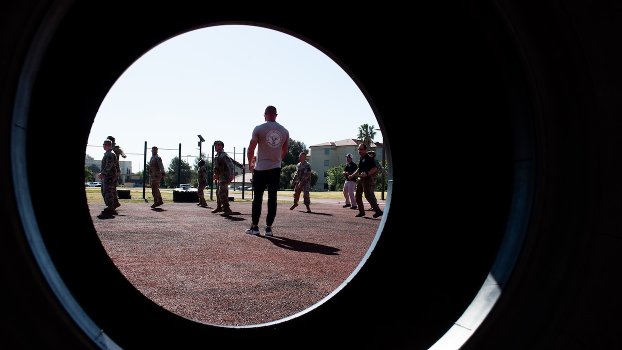 Airmen stretching before obstacle course