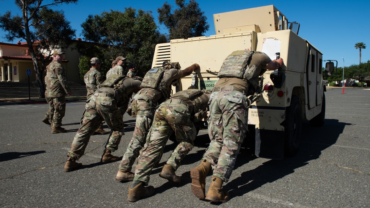 Airmen push Humvee