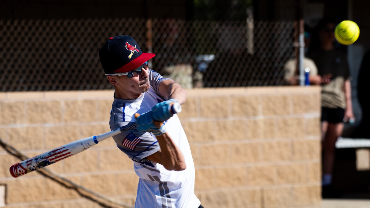 Airman swings a bat at softball