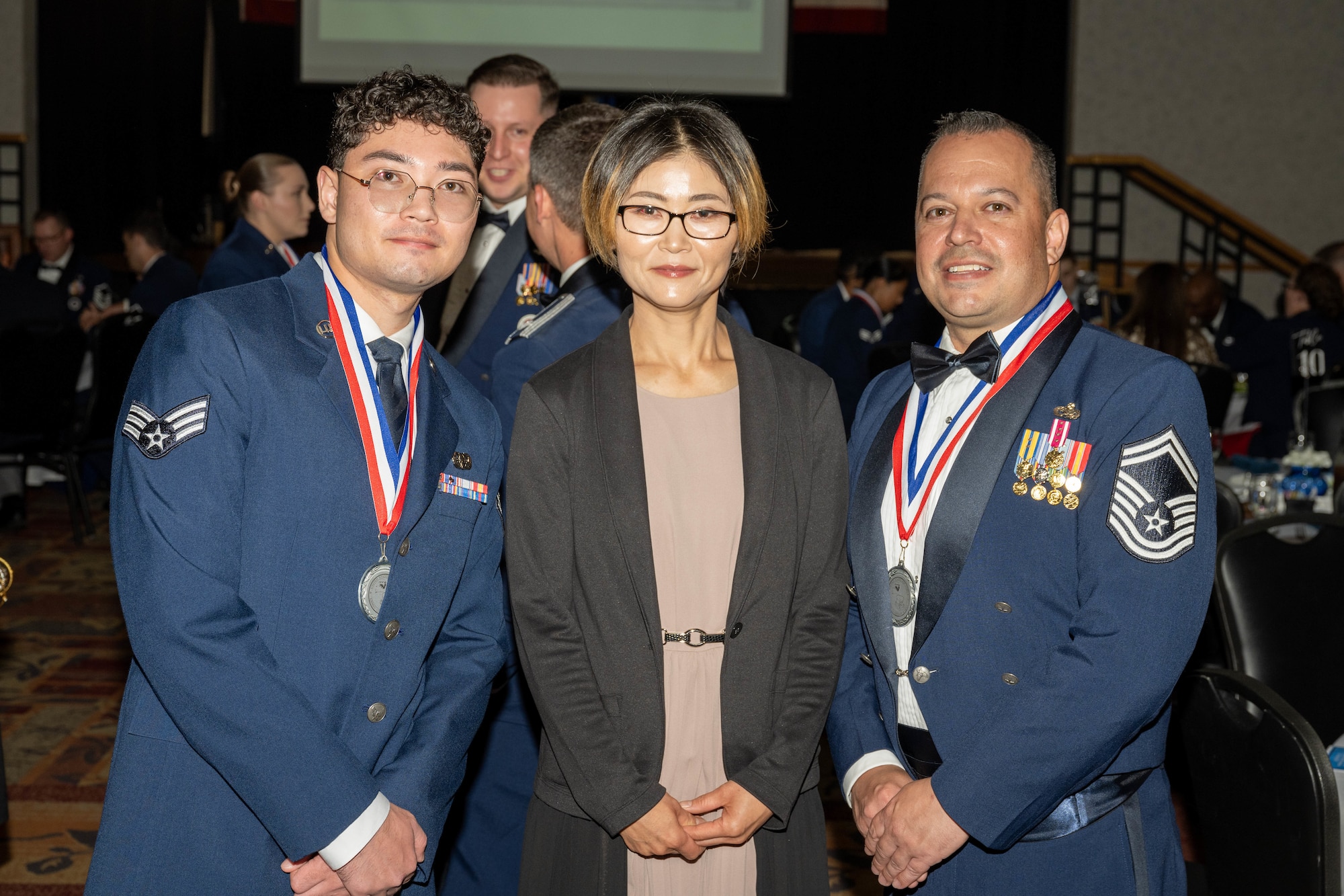 A family poses during the CMSAF Thomas N. Barnes Airman Leadership School Class 25-D graduation.