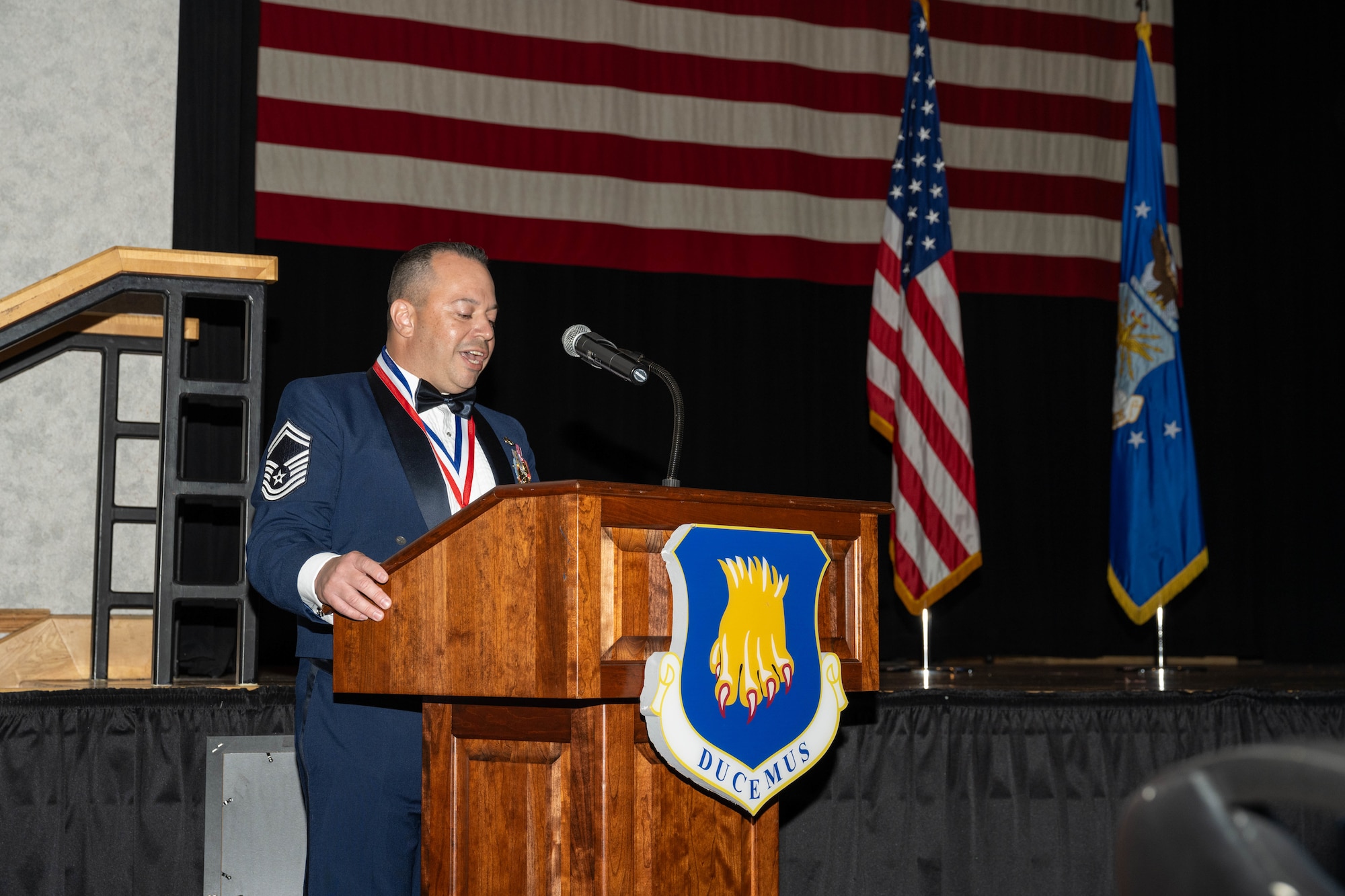 A mentor gives a speech during the CMSAF Thomas N. Barnes Airman Leadership School Class 25-D graduation.