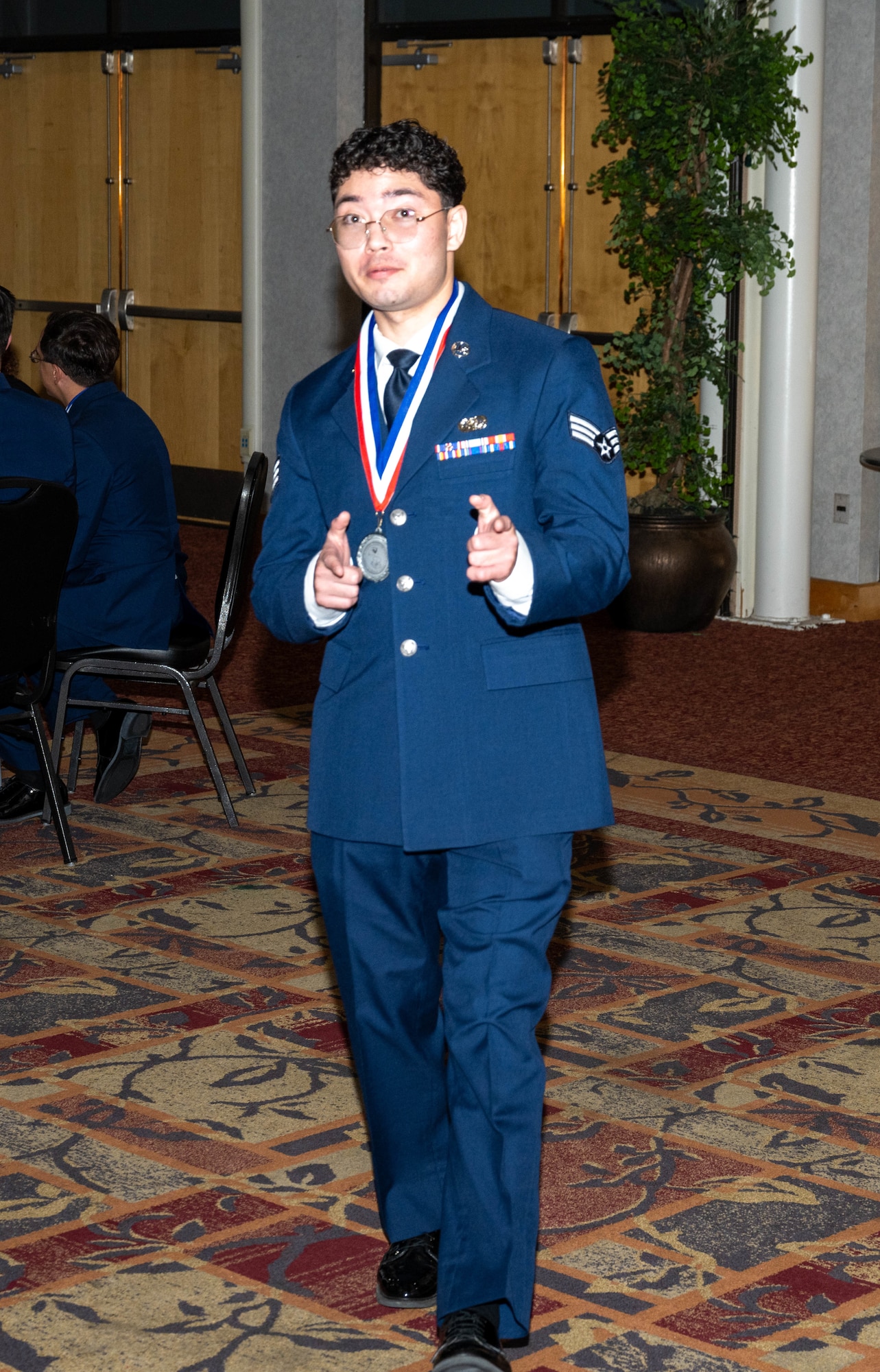 An Airman poses during the CMSAF Thomas N. Barnes Airman Leadership School Class 25-D graduation.