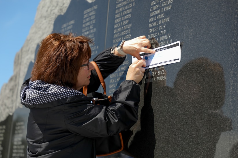 Sherri Gibson, of Knox County, makes an etching of U.S. Army Master Sgt. Bruce Gibson’s name after the Memorial Day remembrance ceremony held at the Kentucky National Guard Memorial at Boone National Guard Center in Frankfort, Kentucky, May 26, 2025.