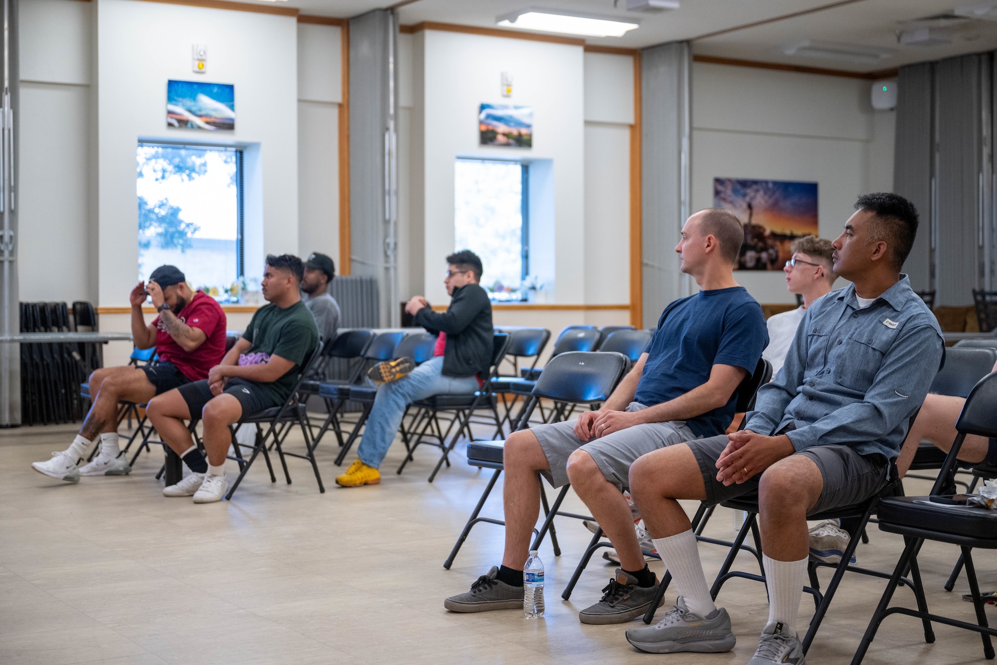 Airmen sit in the base chapel during an Airmen 4 Life meeting.