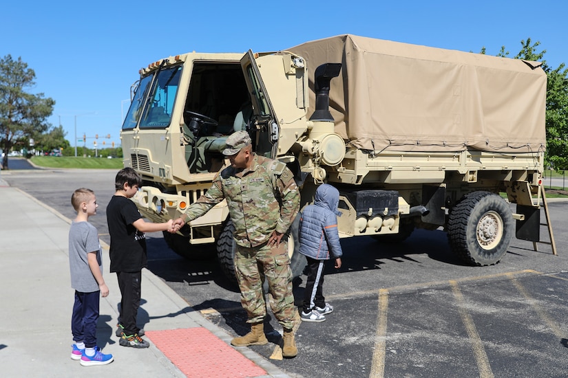Local students meet Spc. Kevin Silva, G3, 85th U.S. Army Reserve Support Command, during a Touch a Truck community event, May 23, 2025.
