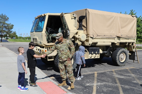 Local students meet Spc. Kevin Silva, G3, 85th U.S. Army Reserve Support Command, during a Touch a Truck community event, May 23, 2025.