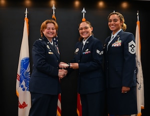 U.S. Air Force Senior Airman Mallory Creech, 315th Training Squadron instructor, receives her degree from Col. Angelina Maguinness, 17th Training Wing commander, and Chief Master Sgt. Khamillia Washington, 17th TRW command chief, as she walks across the stage during Goodfellow’s Community College of the Air Force Fall ‘24 and Spring ‘25 Graduation Ceremony at the Powell Event Center, Goodfellow Air Force Base, Texas, May 21, 2025. The 42 graduates gained their associate's degree through hard work and dedication. (U.S. Air Force photo by Senior Airman Evelyn J. D’Errico)