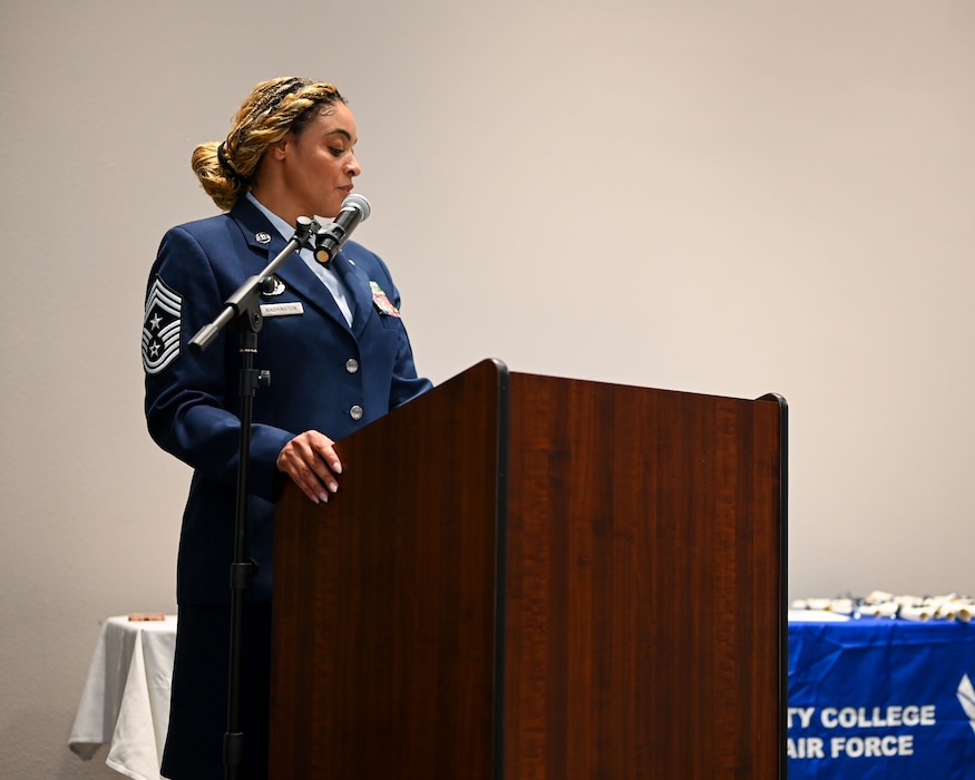 U.S. Air Force Chief Master Sgt. Khamillia Washington, 17th Training Wing command chief, gives words of encouragement during Goodfellow’s Community College of the Air Force Fall ‘24 and Spring ‘25 Graduation Ceremony at the Powell Event Center, Goodfellow Air Force Base, Texas, May 21, 2025. The 42 graduates gained their associate's degree through hard work and dedication. (U.S. Air Force photo by Senior Airman Evelyn J. D’Errico)