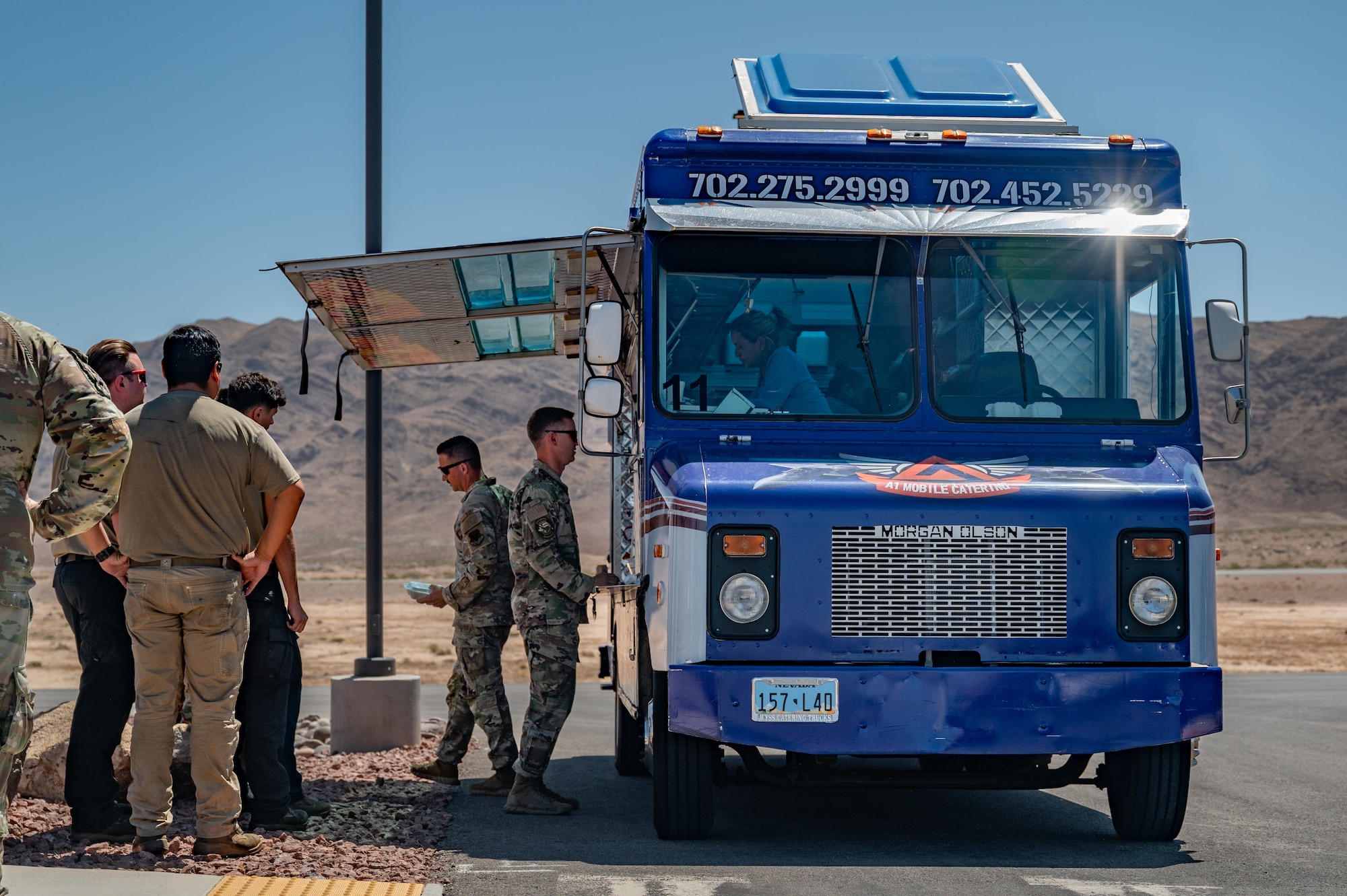 People stand in line at foodtruck.