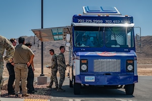 People stand in line at foodtruck.