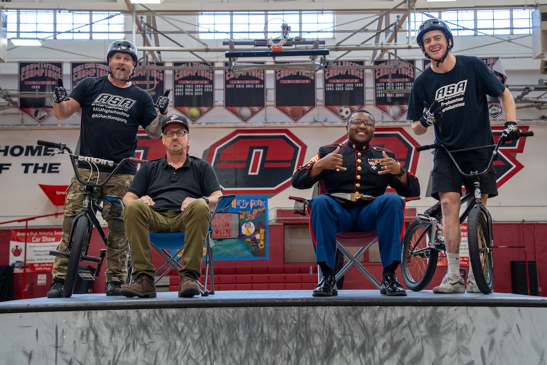 U.S. Marine Corps Sgt. Nicholas Downing, a canvassing recruiter with Recruiting Sub-Station Berkeley, Recruiting Station San Francisco, poses for a photograph with an Arroyo High School faculty member and members of the Action Sports Association during an ASA No Hate Tour event at Arroyo High School in San Lorenzo, California, March 25, 2025. The ASA No Hate Tour, now in its 25th year, is an educational program that uses the energy and excitement of action sports to deliver critical bullying prevention tools, techniques, and information to students. (U.S. Marine Corps photo by Lance Cpl. Avery Wayland)