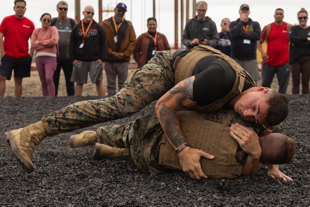 Educators with 12th Marine Corps District watch a Marine Corps Martial Arts Program demonstration during an Educators’ Workshop event at Marine Corps Recruit Depot San Diego in San Diego, May 6, 2025. The Educators Workshop program provides selected educators and influential community members with an experiential opportunity to see how the Marine Corps transforms young men and women into Marines. The workshop also provides attendees with current information regarding Marine Corps training practices, military job skills, service opportunities, military lifestyle, and educational benefits available to Marines. (U.S. Marine Corps photo by Cpl. Bruin Largent)