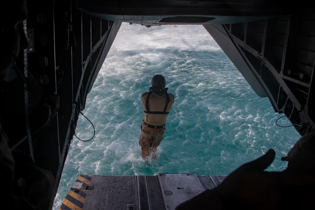A U.S. Marine with Weapons Company, Battalion Landing Team 1st Battalion, 7th Marine Regiment, 31st Marine Expeditionary Unit, jumps out of a CH-53E Super Stallion helicopter attached to Marine Medium Tiltrotor Squadron (VMM) 265 (Rein.), 31st MEU during a helocast at Kin Blue Beach Training Area, Okinawa, Japan, May 21, 2025. The purpose of a helocast is to enhance airborne techniques and enables Marines to insert personnel into a body of water from an aircraft. The 31st MEU, the Marine Corps' only continuously forward-deployed MEU, and provides a flexible force ready to perform a wide-range of military operations across the Indo-Pacific region. (U.S. Marine Corps photo by Sgt. Peter Rawlins)