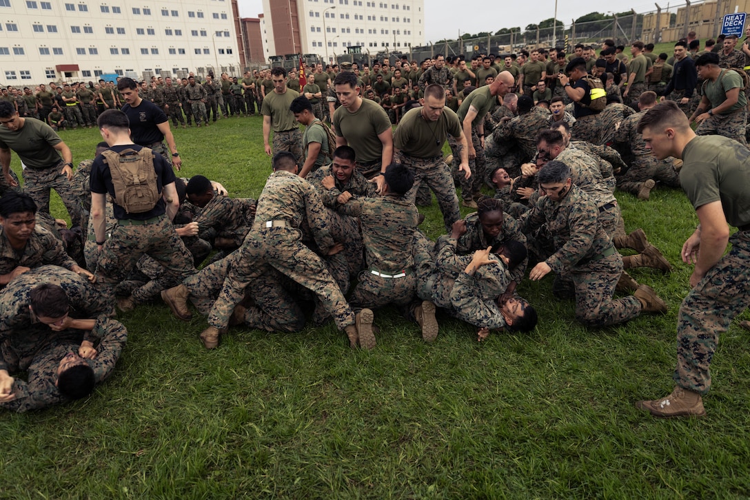 U.S. Marines with Battalion Landing Team 1st Battalion, 7th Marine Regiment, 31st Marine Expeditionary Unit, ground fight during a physical training event on Camp Hansen, Okinawa, Japan, May 23, 2025. The training included a grappling session in order to improve close-quarters combat skills as well as promote unit cohesion and encourage friendly competition between different companies within BLT 1/7. The 31st MEU, the Marine Corps’ only continuously forward-deployed MEU, provides a flexible and lethal force, ready to perform a wide range of military operations as the premiere crisis response force in the Indo-Pacific region. (U.S. Marine Corps photo by Cpl. Angel Diaz Montes De Oca)