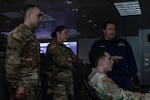 Service members in front of computer system