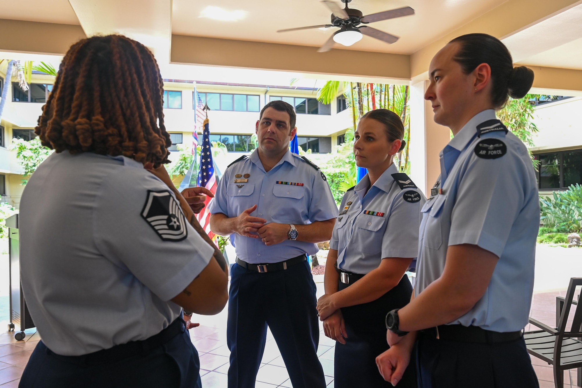 U.S. Air Force Master Sgt. Sherree Cole, Inter-Pacific Air Forces Academy operations superintendent, discusses how ribbons and badges worn on military uniforms differ with Royal Australian Airmen graduating from the Inter-Pacific Junior Enlisted Leader Forum (IPJELF) at Joint Base Pearl Harbor-Hickam, Hawaii, May 19, 2025. The academy aims to equip non-commissioned officers with the leadership skills and problem-solving methods needed to succeed in multinational operational environments. (U.S. Air Force photo by Senior Airman Melody Bordeaux)