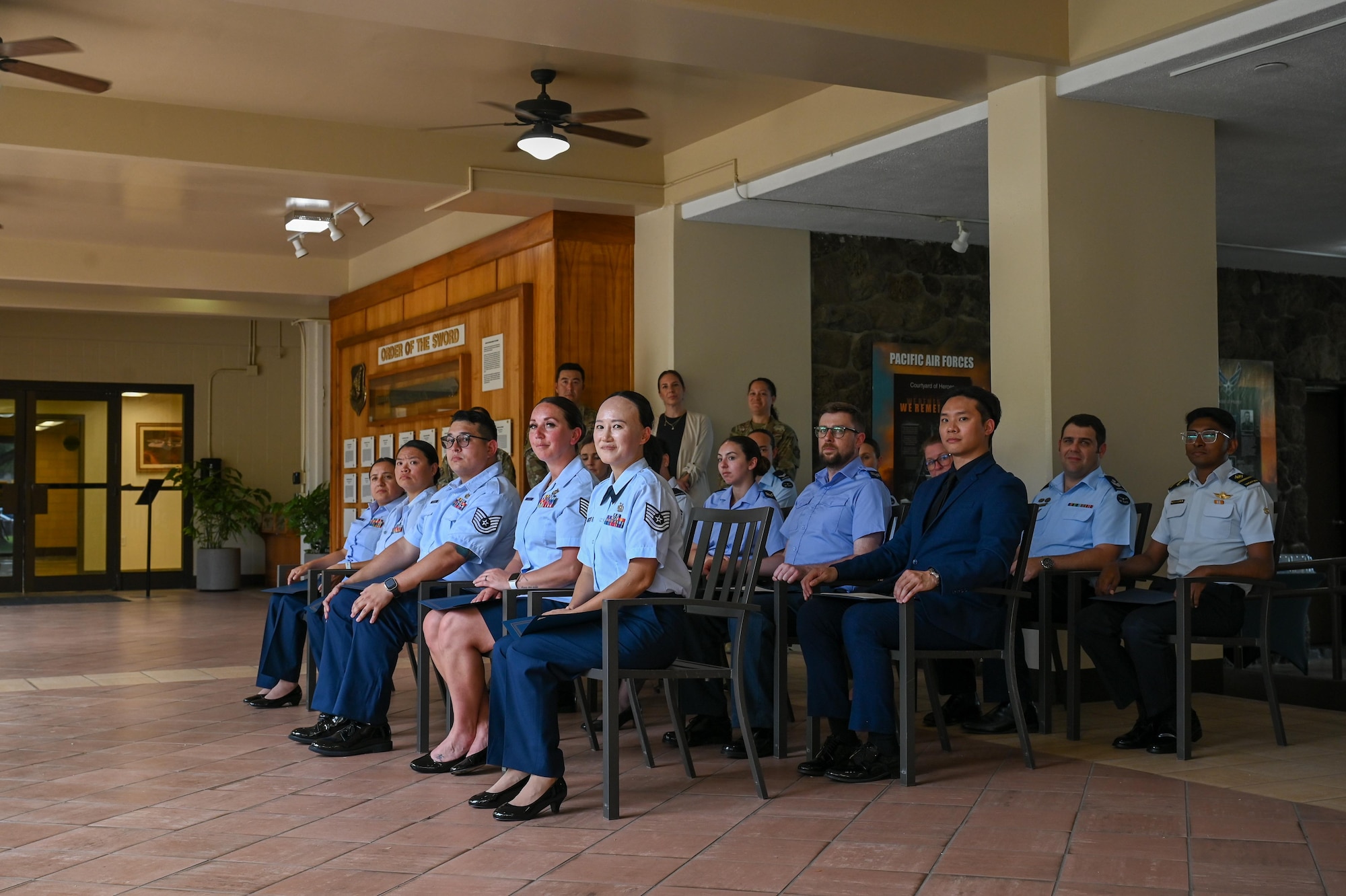 Multinational service members from Indo-Pacific allied and partnered air forces wait to graduate from the Inter-Pacific Junior Enlisted Leader Forum (IPJELF) at Joint Base Pearl Harbor-Hickam, Hawaii, May 19, 2025. The IPJELF participants shared experiences and worked to form bonds to strengthen international partnerships and arm them with new connections and experiences to help the success of future partnered missions. (U.S. Air Force photo by Senior Airman Melody Bordeaux)