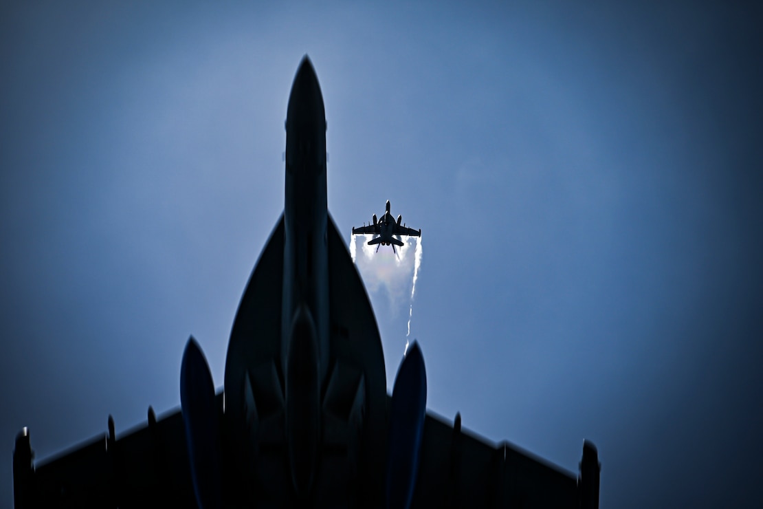 E/A-18G Growlers from the “Cougars” of Electronic Attack Squadron (VAQ) 139 fly near the aircraft carrier USS Nimitz (CVN 68) in the South China Sea, May 27, 2025.