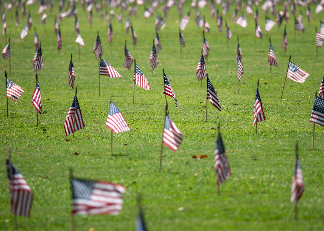 Flags, placed by more than 1,000 Scouts from Scouting America, wave over more than 53,000 gravesites at the National Memorial Cemetery of the Pacific at Punchbowl Crater May 25.
