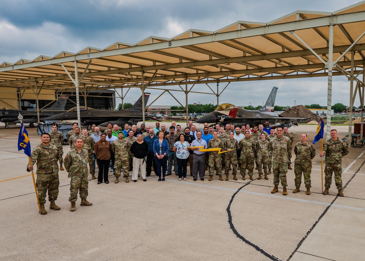 Personnel assigned to 502nd Communication Squadron and 149th Fighter Wing who participated in the "One Base One Network" initiative pose for a photo at Joint Base San Antonio-Lackland, Texas, April 29, 2025. This initiative integrates the Texas Air National Guard 149FW into the Department of the Air Force enterprise network on JBSA-Lackland to consolidate multiple networks under a single, secure and efficient platform that enhances cybersecurity, improves mission effectiveness and streamlines operations for all mission partners. (U.S. Air Force photo by Zelideth Rodriguez)