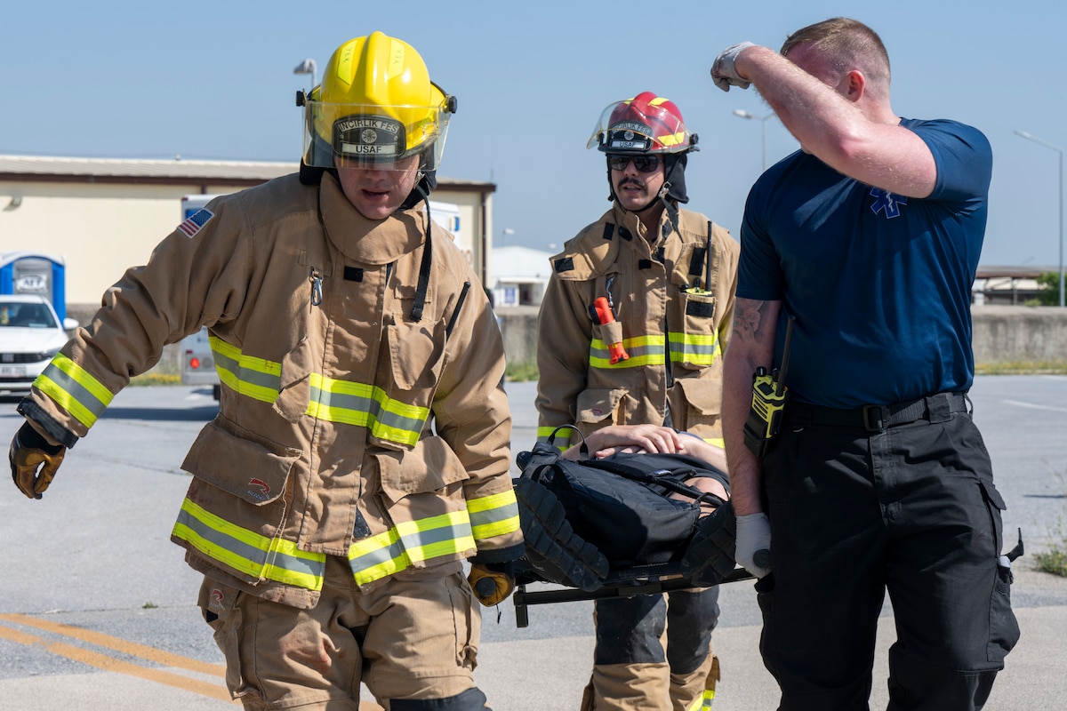 U.S. Air Force Airmen, assigned to the 39th Air Base Wing, transport a simulated casualty to an ambulance during exercise Titan Shield 25-04 at Incirlik Air Base, Türkiye, May 21, 2025. The mass casualty scenario challenged the medical team’s readiness by simulating a surge of patients, reinforcing critical care coordination under pressure. (U.S. Air Force photo by Senior Airman Vaughn Weber)