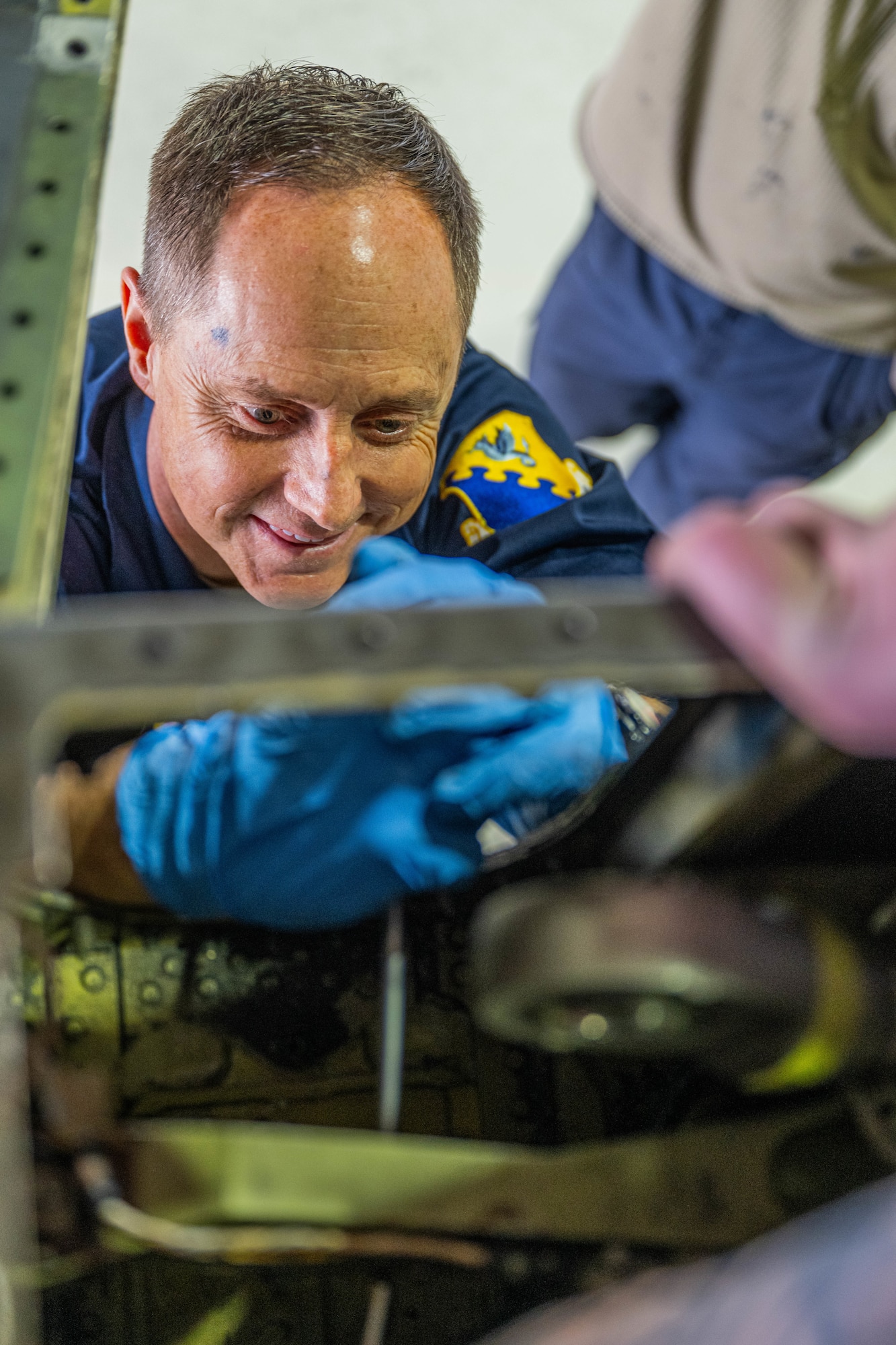 An Airman performs maintenance on a jet.