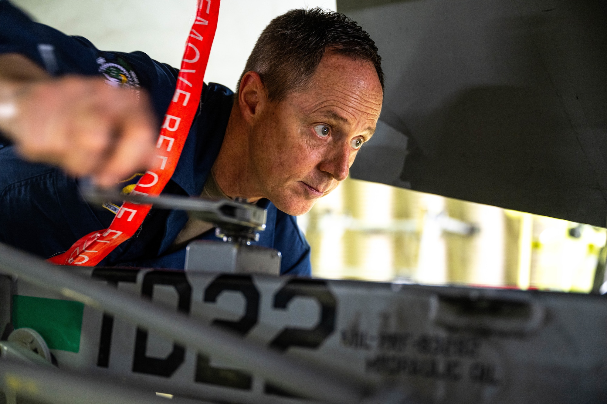 An Airman performs maintenance on a jet.