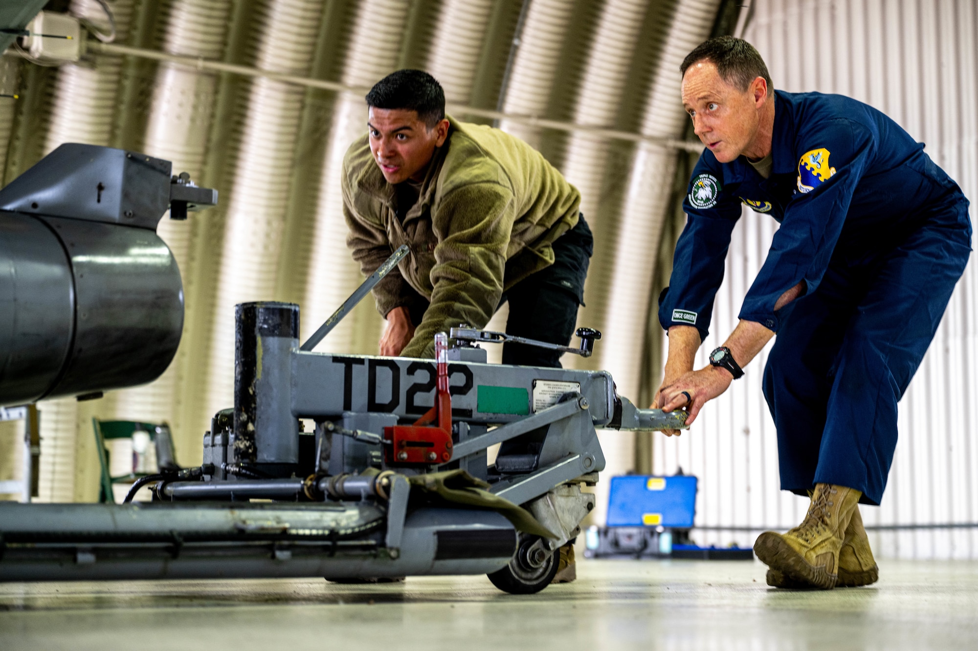 An Airman performs maintenance on a jet.