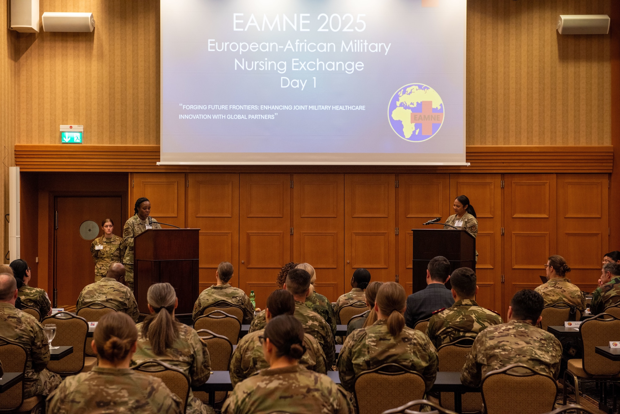 U.S. Air Force Maj. Savannah Jump, Landstuhl Regional Medical Center director of hospital education and training, and Maj. Keshia Brown, LRMC primary care flight commander, give opening remarks at the European-African Military Nursing Exchange conference in Garmisch-Partenkirchen, Germany, May 20, 2025. This year’s EAMNE theme, “Forging Future Frontiers: Enhancing Joint Military Healthcare Innovation with Global Partners,” aimed to enhance collaboration and interoperability between the U.S. and its partner nations. (U.S. Air Force photo by Airman 1st Class Jason Jones Jr.)
