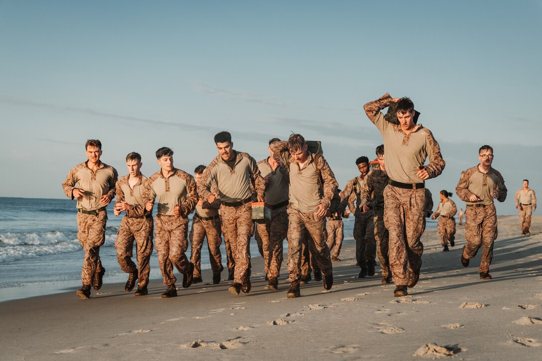 U.S. Marines and Sailors participate in a beach workout during a Corporal's Course hosted by the 26th Marine Expeditionary Unit at Camp Lejeune, North Carolina, May 23, 2025. Corporal's Course is designed to provide Marines and Sailors with the basic knowledge and skills necessary to assume greater responsibility as noncommissioned officers. (U.S. Marine Corps photo by Cpl. Osmar VasquezHernandez)