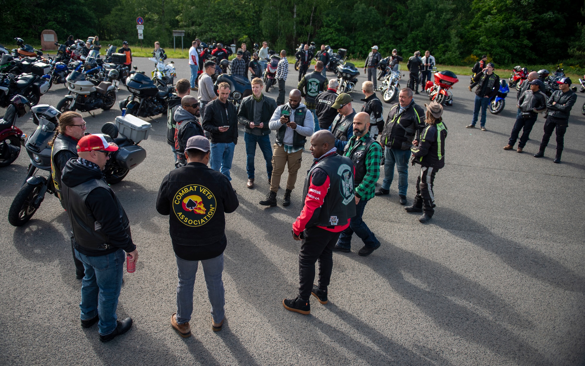 Kaiserslautern Military Community members exchange greetings prior to the mentorship ride at Ramstein Air Base, Germany, May 27, 2025. The mentorship ride brought awareness to safety precautions while riding in addition to building morale and camaraderie within the KMC community. (U.S. Air Force photo by Senior Airman Sabrina Fuller-Judd)