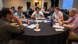 Airmen in group 6 discuss a leadership scenario at the 47 Flying Training Wing Leadership Summit at Laughlin Air Force Base, Texas, May 22, 2025. Airmen of all different ranks and roles offered insight on how leadership should be applied to different scenarios. (U.S. Air Force photo by Staff Sgt. Nicholas Larsen)