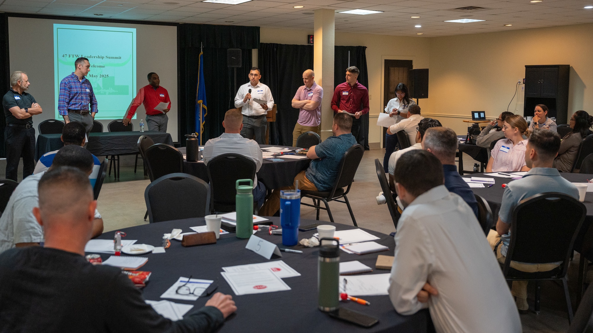 Representatives from various groups at the 47th Flying Training Wing Leadership Summit discuss the leadership decisions their groups made at Laughlin Air Force Base, Texas, May 22, 2025. When showing their conclusions, groups compared and contrasted their decision-making process. (U.S. Air Force photo by Staff Sgt. Nicholas Larsen)
