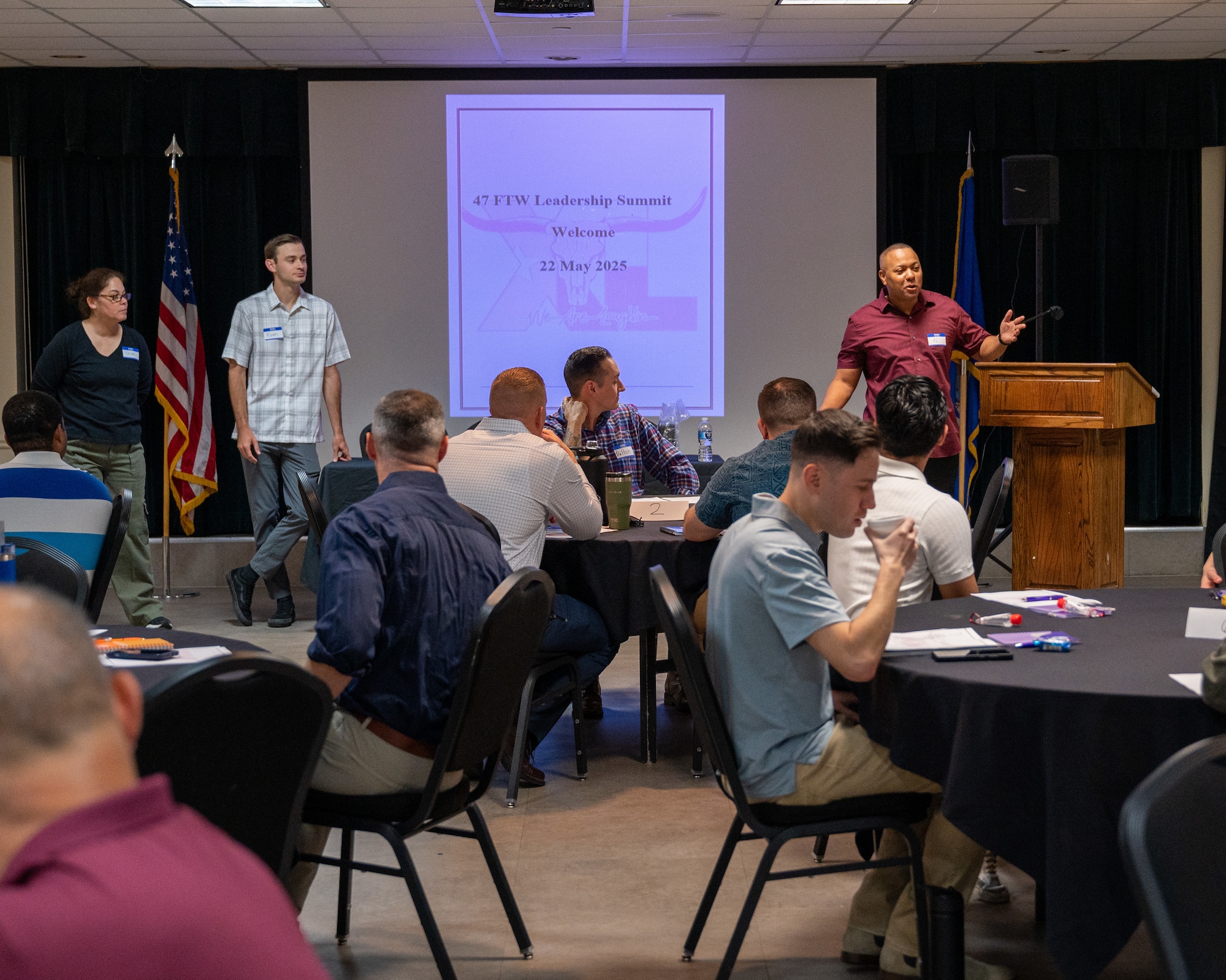 U.S. Air Force Master Sgt. Alvin Morris, right, 47th Security Forces Squadron superintendent, speaks with the attendees at the 47 Flying Training Wing Leadership Summit at Laughlin Air Force Base, Texas, May 22, 2025. Airmen worked as groups to figure out how to address different scenarios presented to them. (U.S. Air Force photo by Staff Sgt. Nicholas Larsen)
