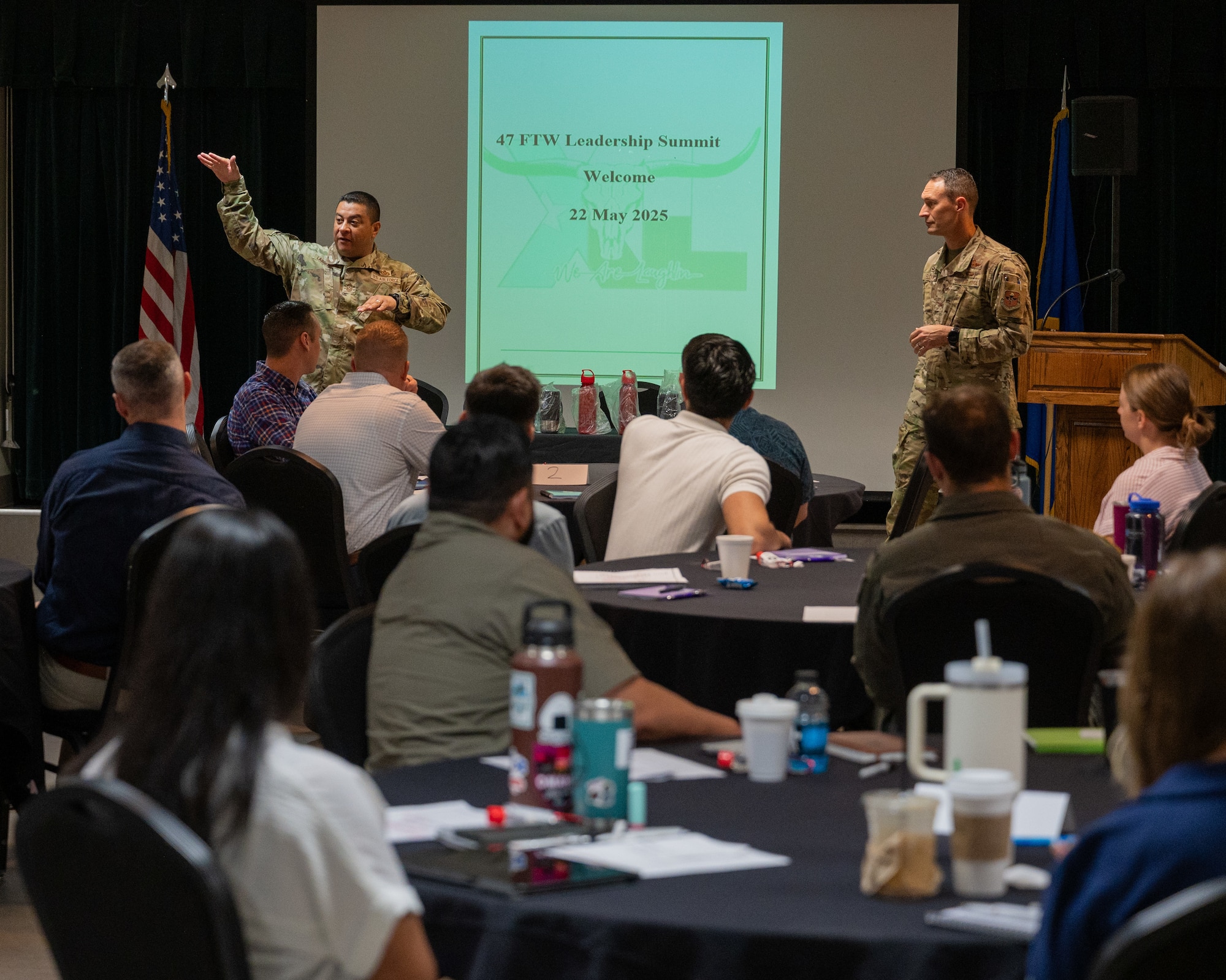 U.S. Air Force Chief Master Sgt. Lester Largaespada, left, 47 Flying Training Wing (FTW) command chief, and Col. Tyler Ellison, right, 47 FTW commander, speak at the 47 Flying Training Wing Leadership Summit at Laughlin Air Force Base, Texas, May 22, 2025. The Leadership Summit provided opportunities for Non-Commissioned Officers, Officers, and Civilians to deal with scenarios in a leadership capacity in small groups. (U.S. Air Force photo by Staff Sgt. Nicholas Larsen)